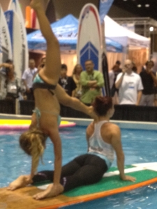 SUP yoga enthusiasts at Surf Expo on Saturday